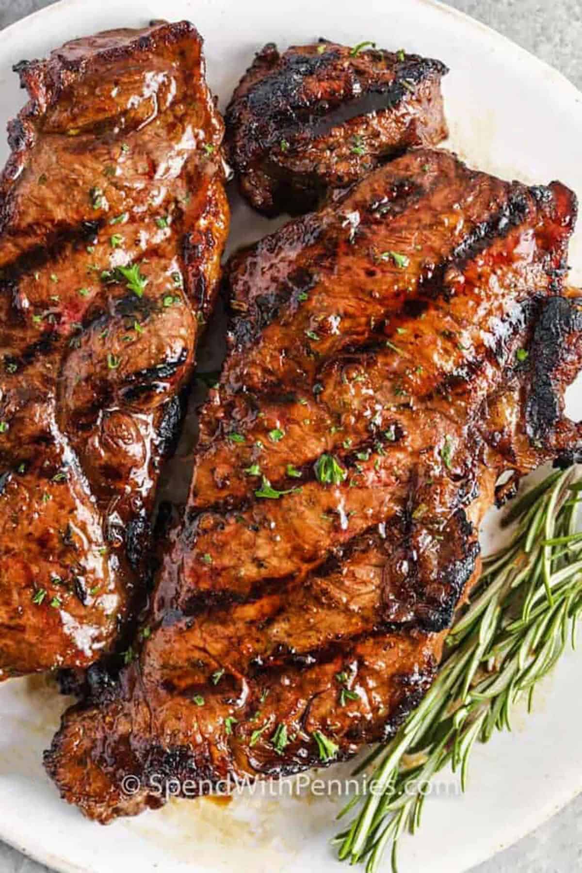plated steaks with Steak Marinade and rosemary