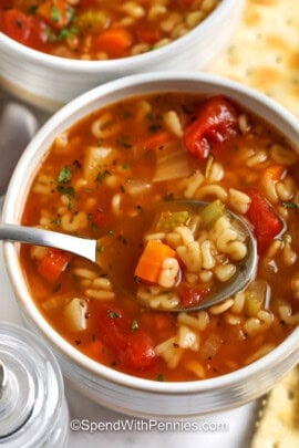bowl full of Alphabet Soup with some on a spoon