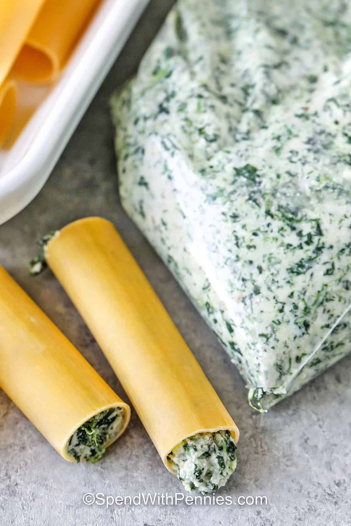 adding filling to pasta to make Cheese Cannelloni