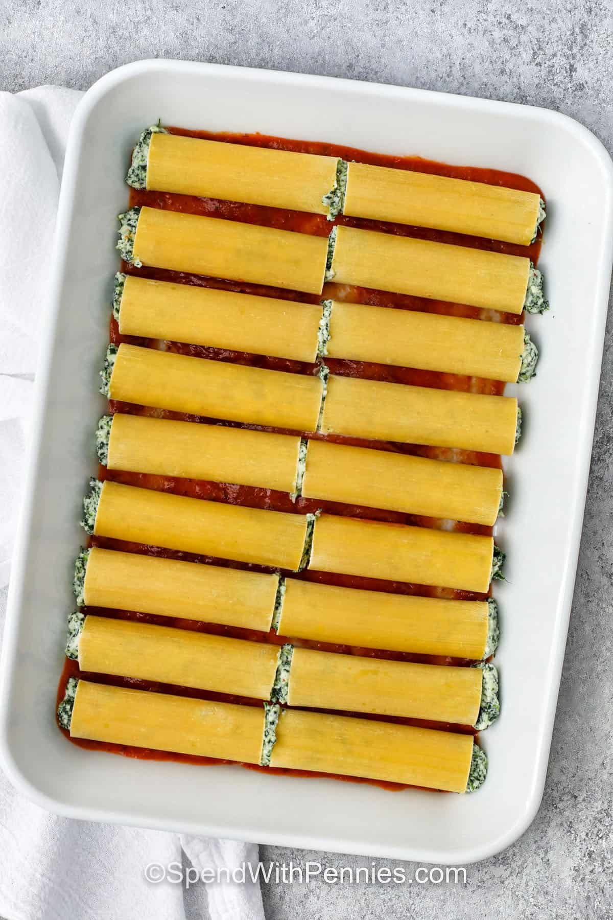 adding Cheese Cannelloni to pasta sauce in casserole dish