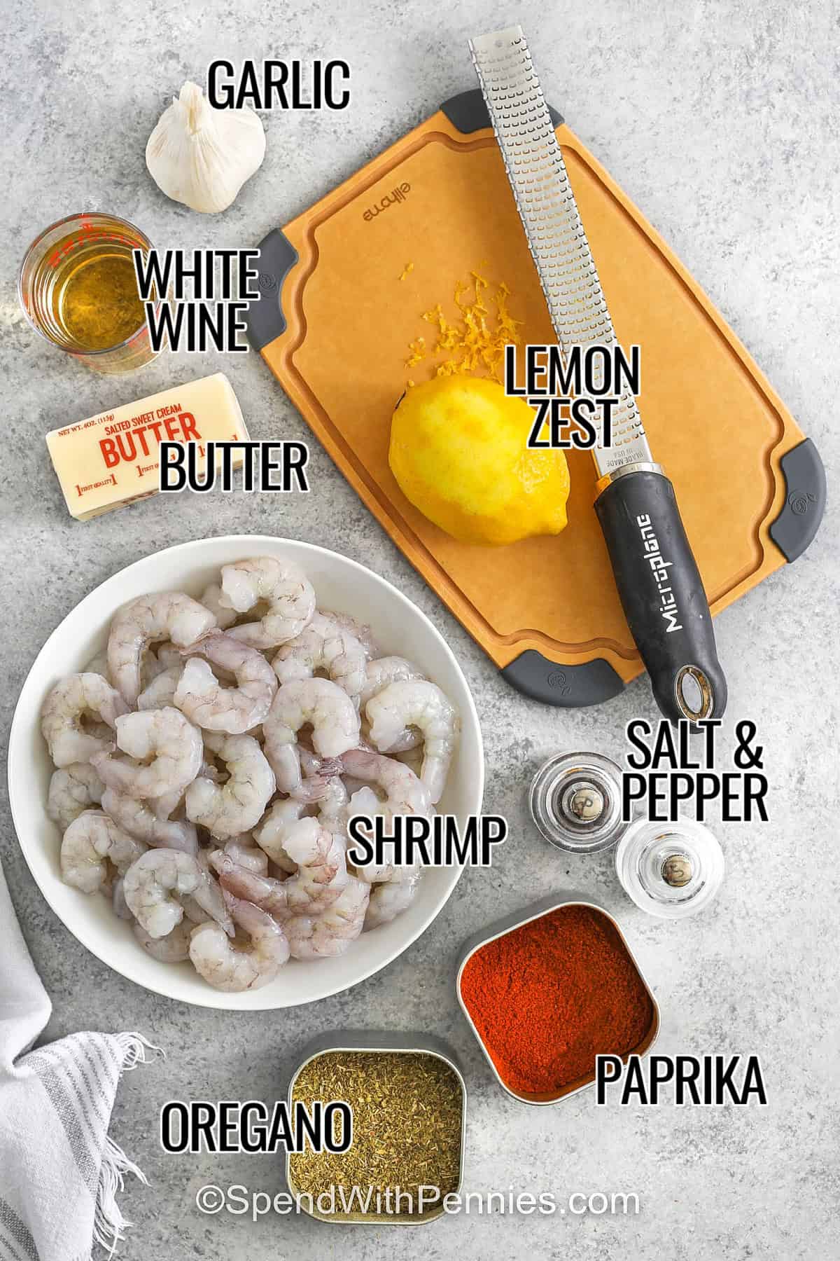 garlic , butter , white wine , lemon zest , shrimp , oregano , paprika , salt and pepper with labels to make Oven Baked Shrimp