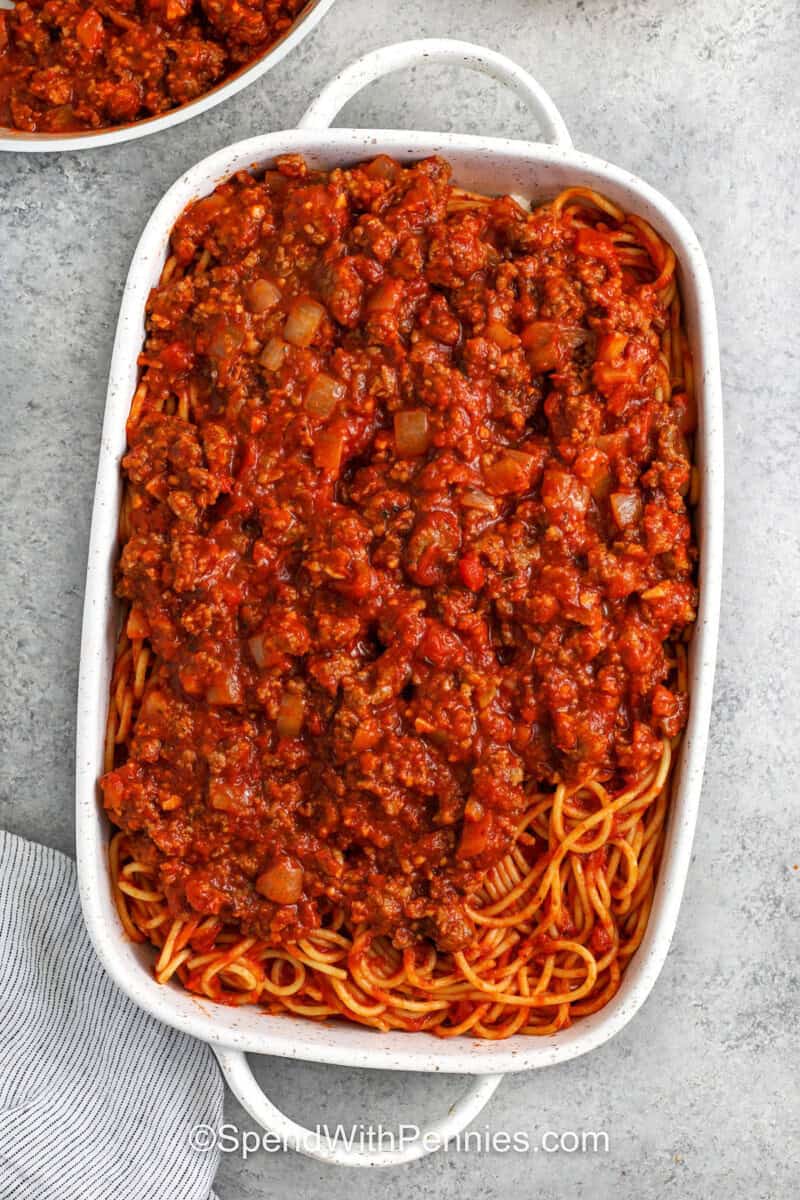 adding meat sauce layer to dish to make Million Dollar Spaghetti