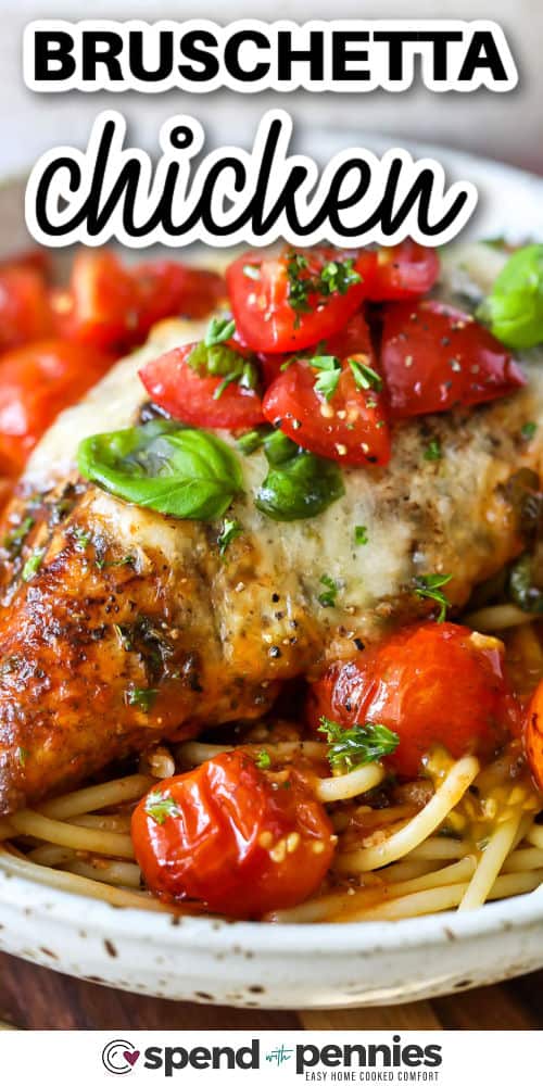 Bruschetta chicken takes tender baked chicken breast and layers it with marinara, cherry tomatoes, and mozzarella. A balsamic-kissed tomato and basil topping brings it all together. This easy Italian-inspired recipe is perfect for serving with pasta, zucchini noodles, or even mashed potatoes for a meal that’s as beautiful looking as it is delicious. #spendwithpennies close up of juicy Bruschetta Chicken