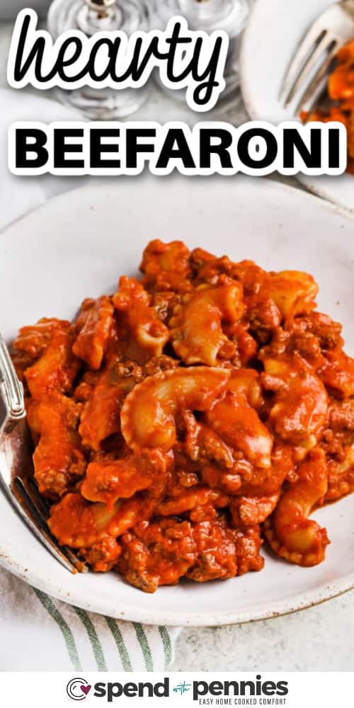 Beefaroni is an old fashioned favorite that’s even better when made from scratch. This cheesy, savory pasta dinner comes together in one pot on the stovetop for easy prep and cleanup. Ground beef, crushed tomatoes, and a creamy sauce make this the best family comfort food, perfect for serving with garlic bread or a crisp green salad. #spendwithpennies hearty Homemade Beefaroni in a bowl with a fork