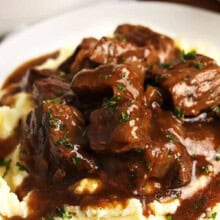 juicy Beef Tips and mashed potatoes on a plate
