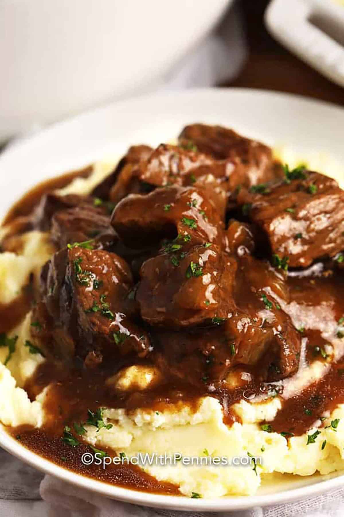 juicy Beef Tips and mashed potatoes on a plate