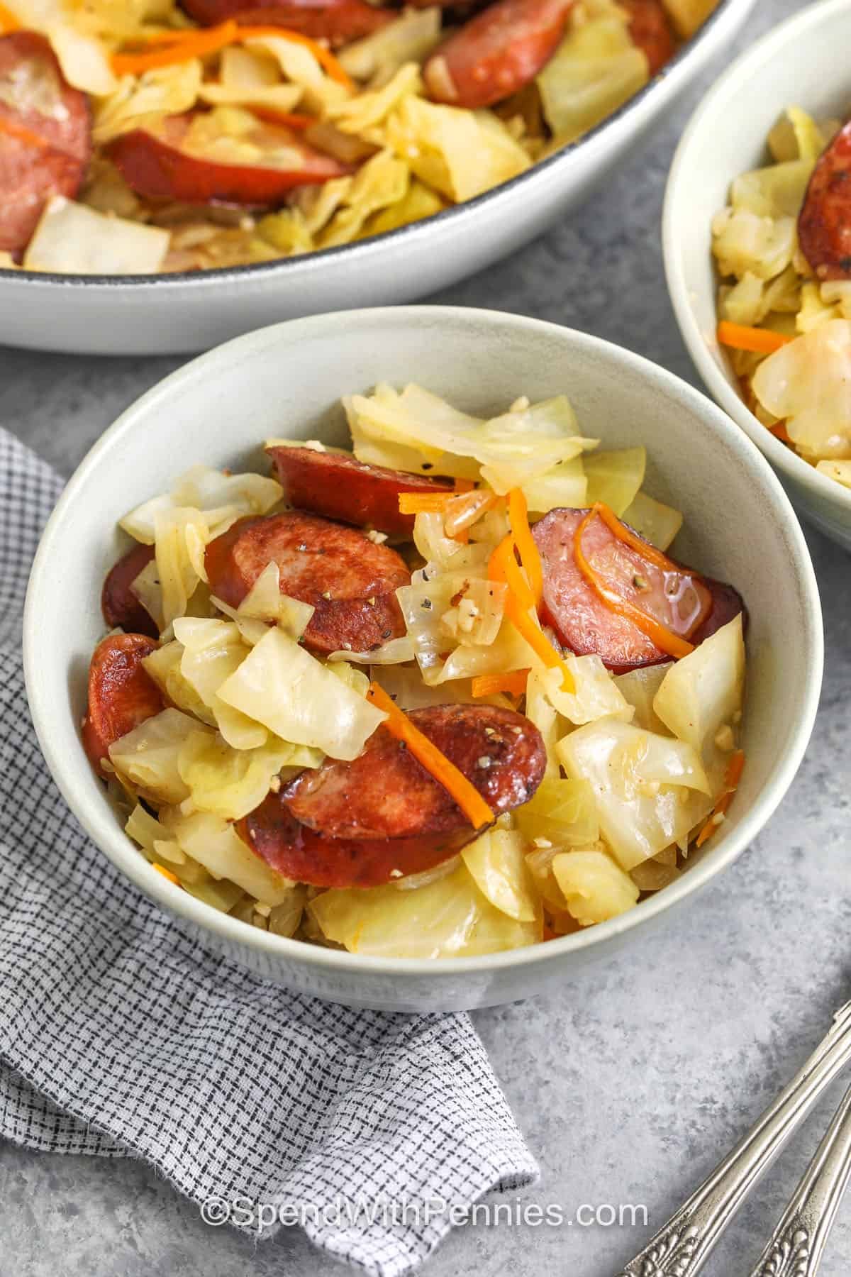a bowl of cabbage and sausage