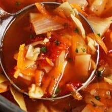 Cabbage soup being ladled in a pot