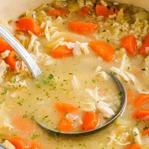 chicken soup prepared in a bowl with a ladel.