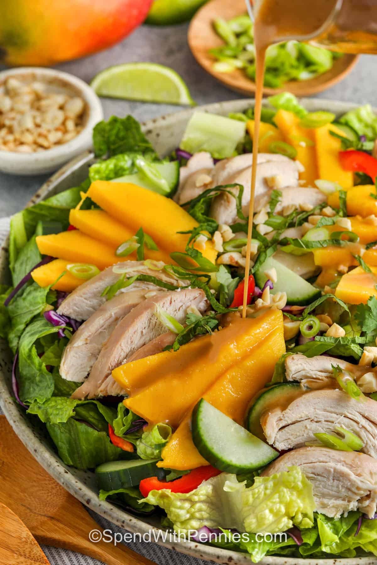 adding sesame dressing to Mango Chicken Salad