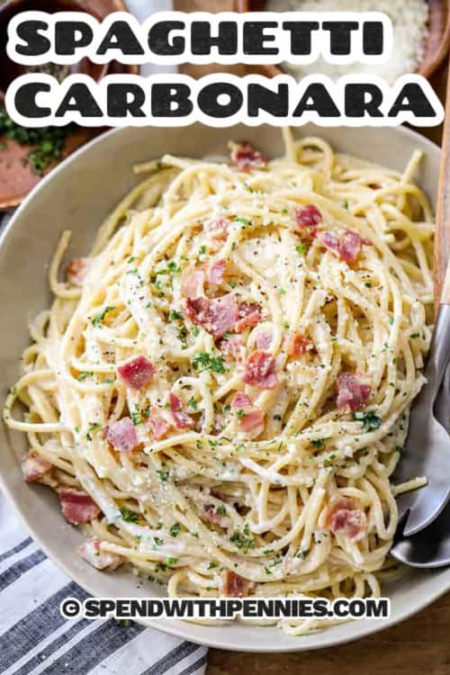 Spaghetti carbonara is a rich, creamy pasta dish made with eggs, Parmesan cheese, and crispy bacon. This simple Italian classic comes together in under 30 minutes with just a handful of ingredients. It’s the perfect quick meal that feels fancy but is so easy to make. Serve with a sprinkle of black pepper and extra cheese for the ultimate comfort dish. #spendwithpennies Spaghetti Carbonara with a title