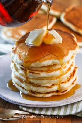 adding syrup of a stack of pancakes
