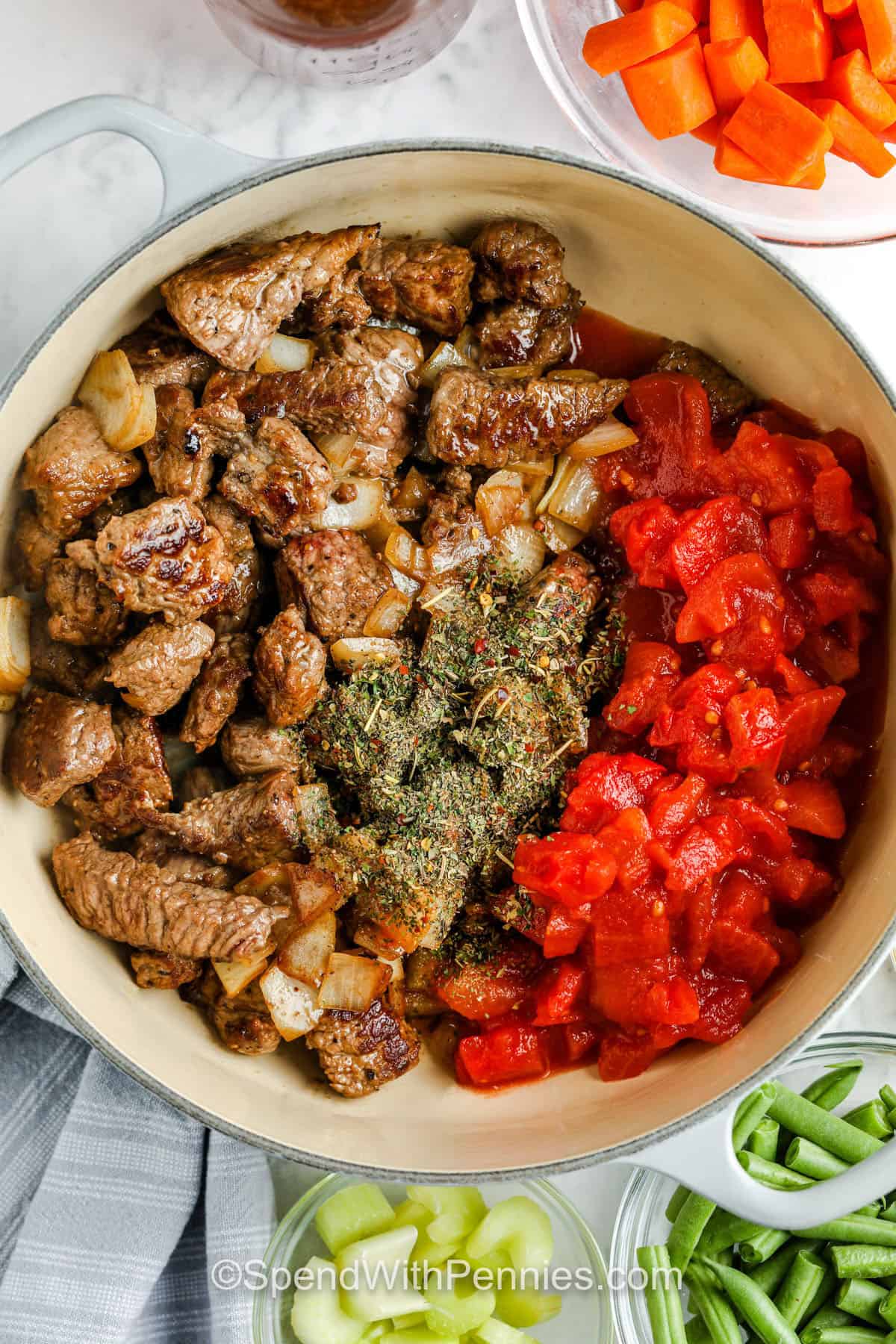 adding seasonings to beef and veggies to make Vegetable Beef Soup