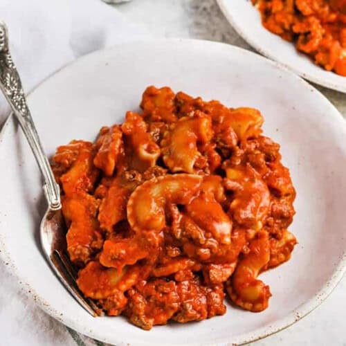 beefaroni in a white bowl with a fork
