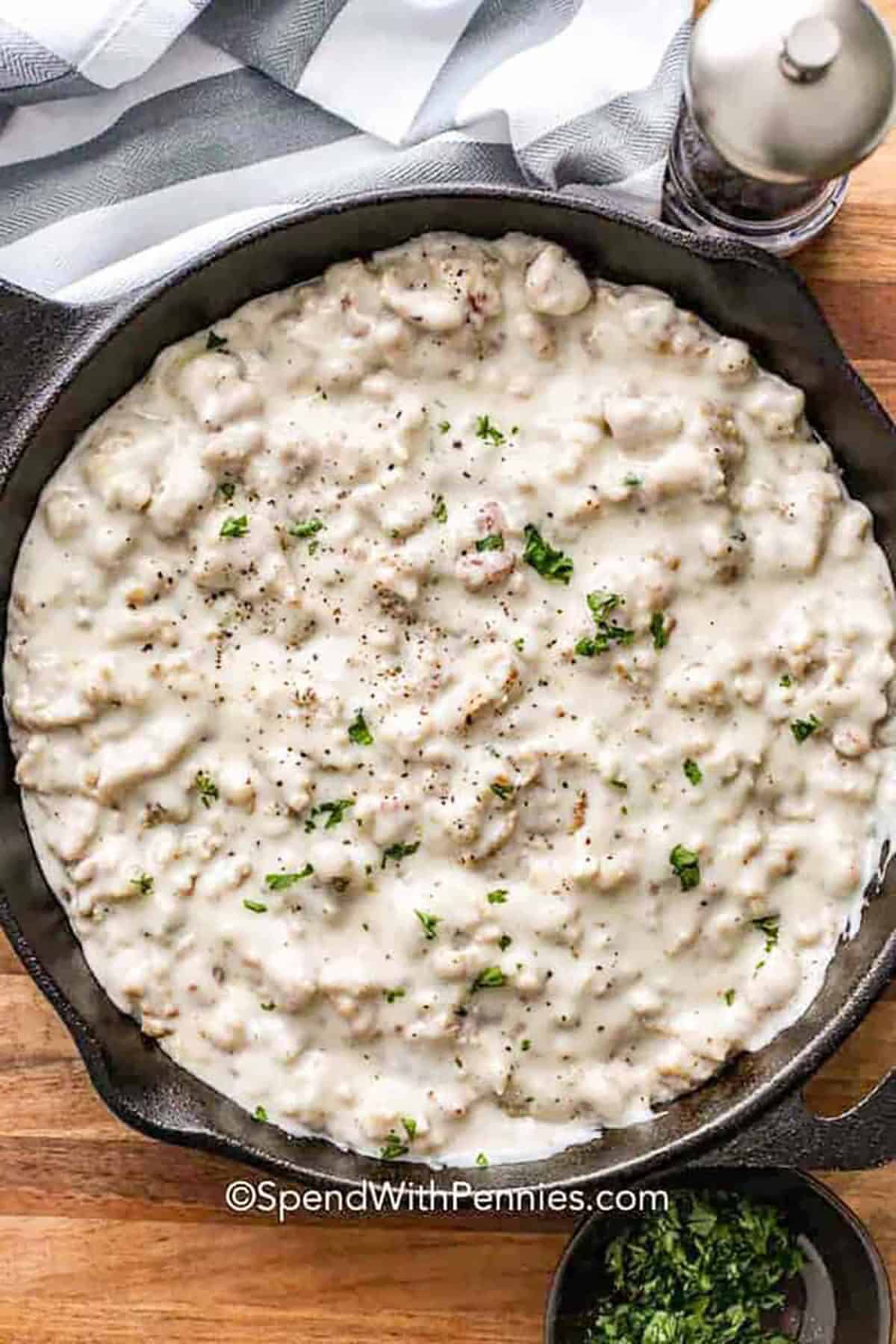 This sausage gravy recipe is a classic family favorite that is so creamy and delicious. It starts with a meaty and tender breakfast sausage that is pan fried. Some butter is melted in the same pan, along with some flour, and milk is slowly whisked into the sauce. The result is a velvety sauce that packs a punch of flavor. Serve it over morning biscuits, potatoes, or as a base for a casserole. #spendwithpennies pan of Sausage Gravy Recipe
