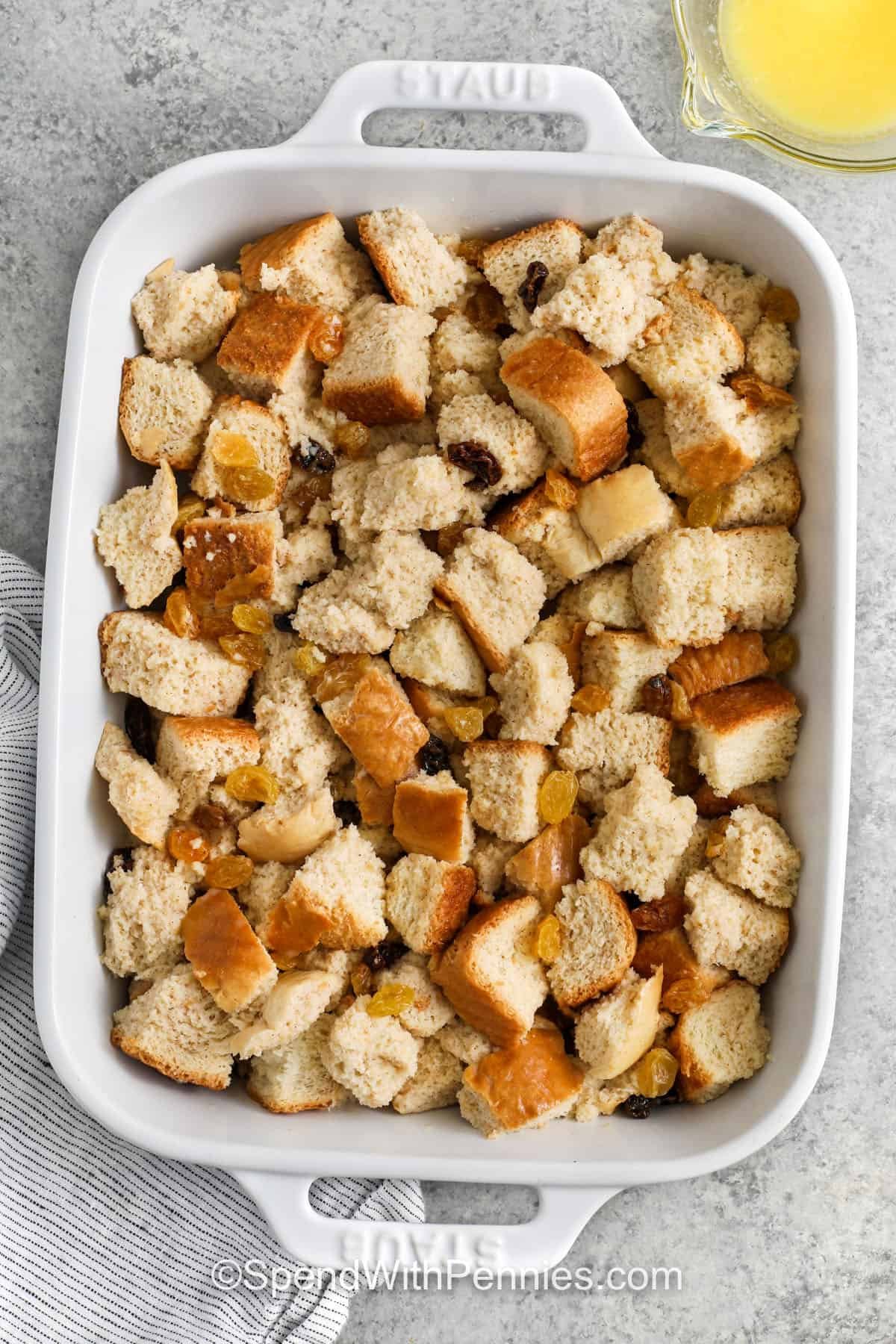 adding dry ingredients to casserole dish to make Bread Pudding Recipe