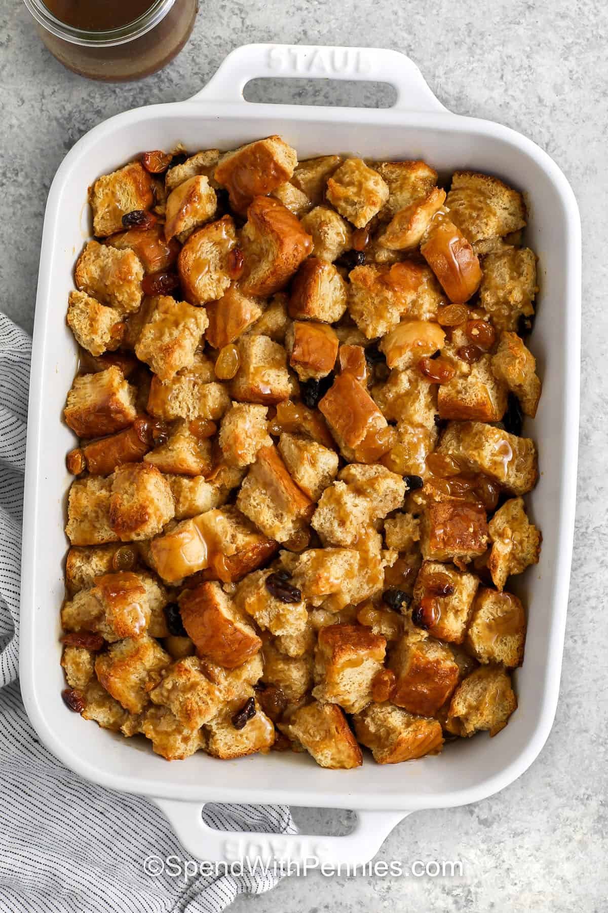 adding caramel sauce on top of Bread Pudding Recipe