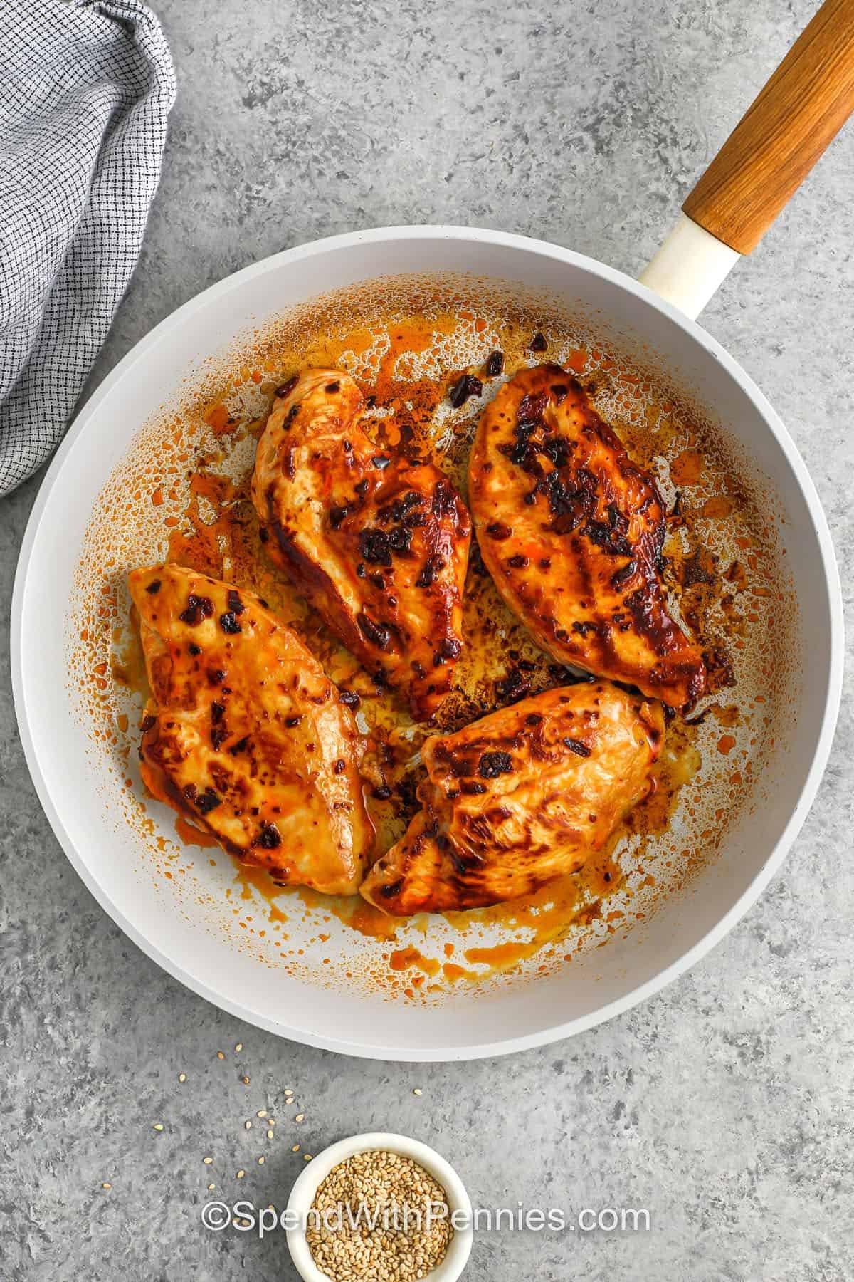 cooking chicken in a pan to make Chili Crisp Chicken