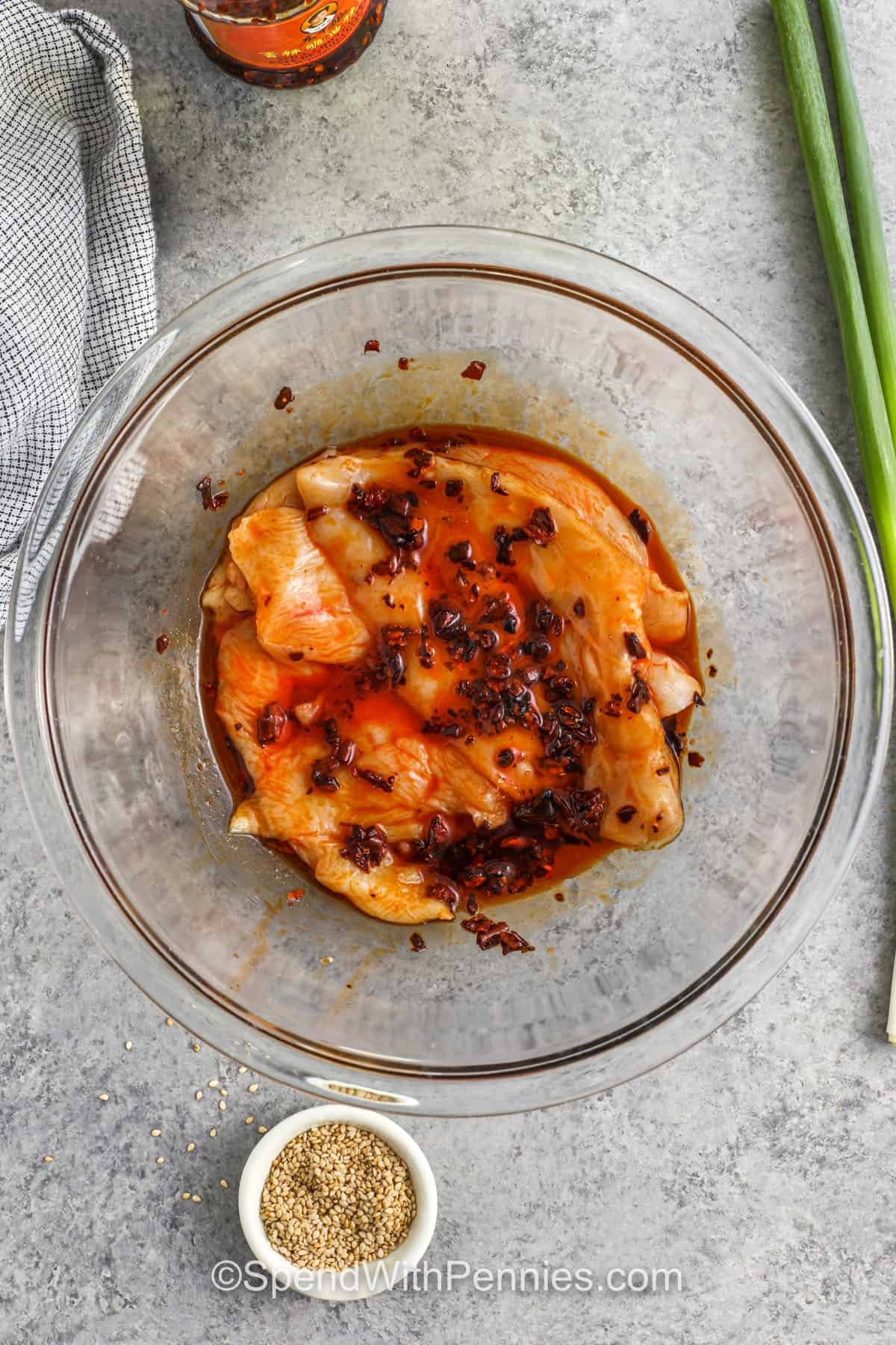 adding chili crisp to chicken to make Chili Crisp Chicken