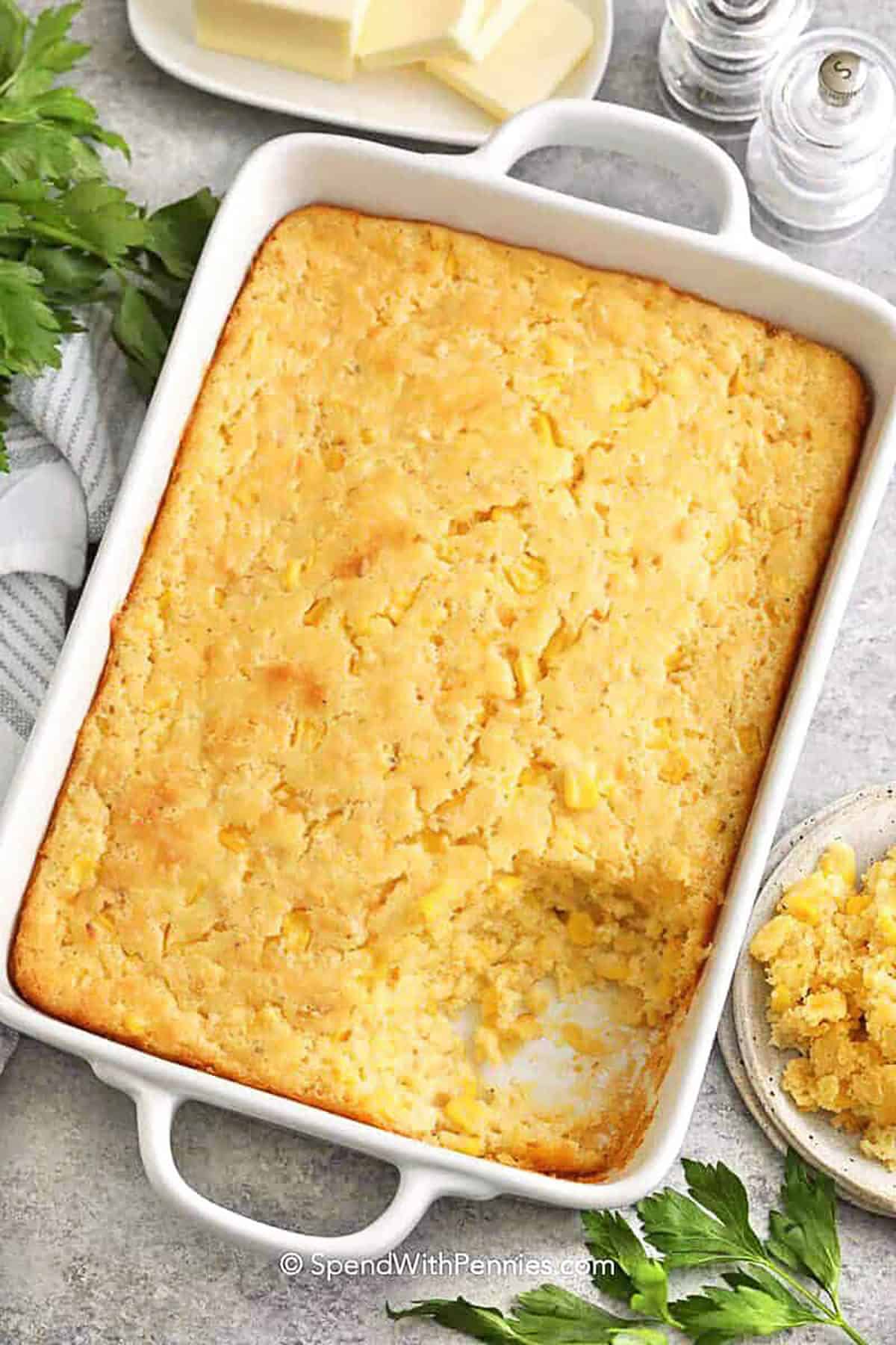 top view of baked corn casserole with a piece taken out