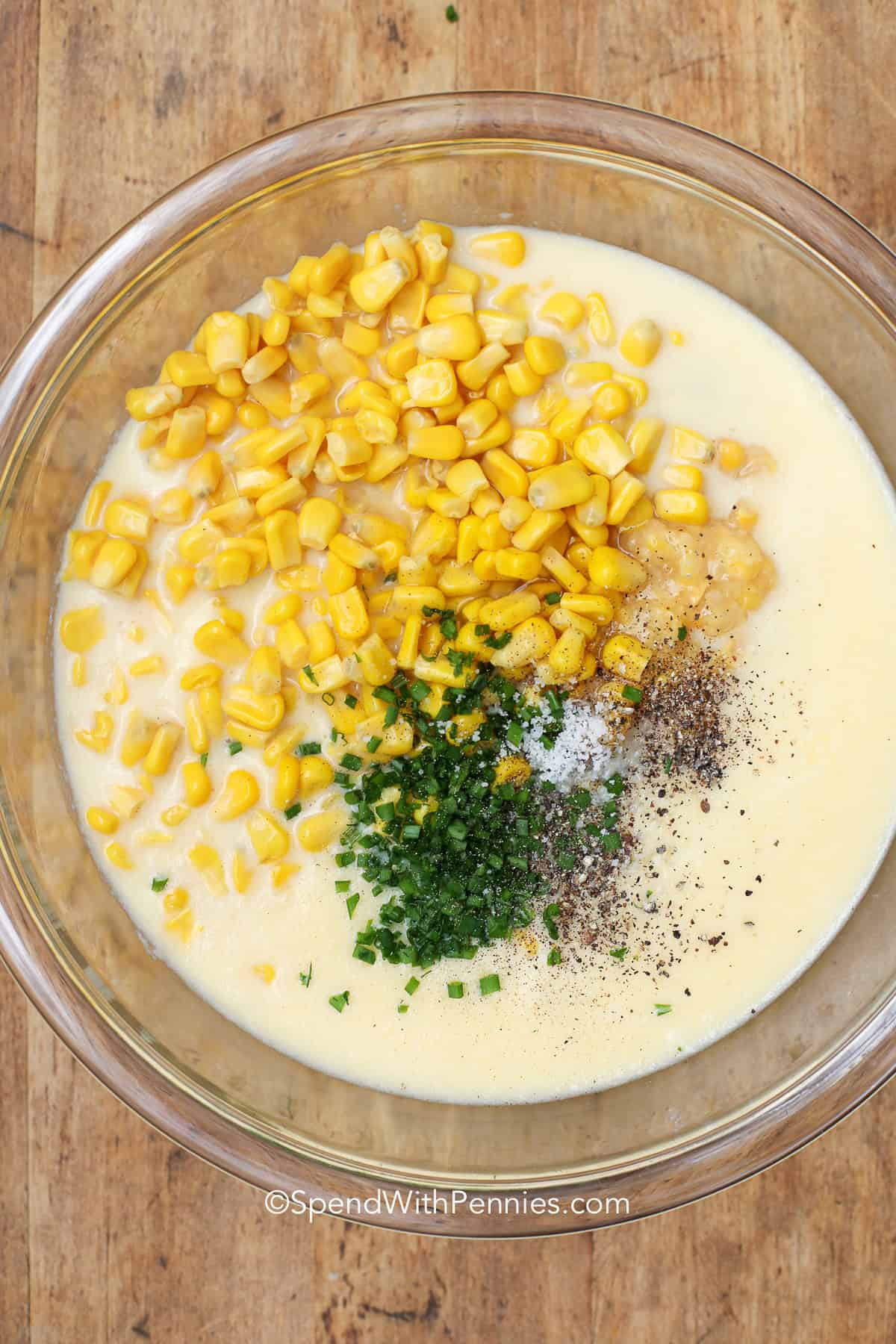 Corn pudding is a creamy, classic dish that combines the sweetness of corn with buttery richness. This recipe is simple to make and turns out a custard-style casserole that’s soft, golden, and delicious. Perfect for Thanksgiving or any special dinner, it’s a southern-inspired favorite that feels homemade and comforting every time. #spendwithpennies unmixed ingredients in a bowl to make corn pudding