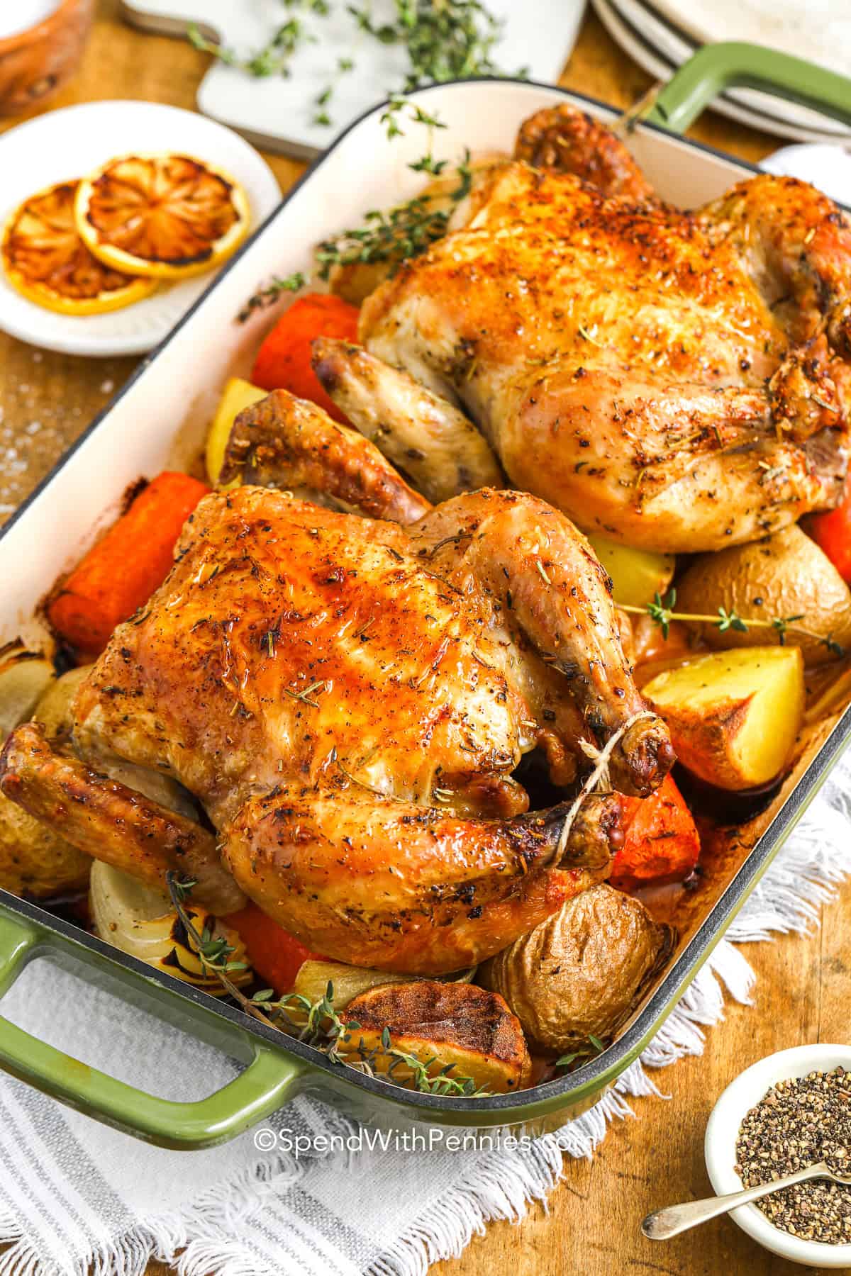 Cornish hen makes for an elegant yet easy dinner, seasoned with rosemary, thyme, and lemon zest. Roasted to golden perfection over tender carrots, onions, and potatoes, this one-pan meal delivers savory flavor in every bite. The skin turns perfectly crisp while the meat stays juicy and flavorful. A simple seasoning blend brings out the natural richness of the hen. #spendwithpennies A cooked cornish hen recipe with vegetables in a baking pan.