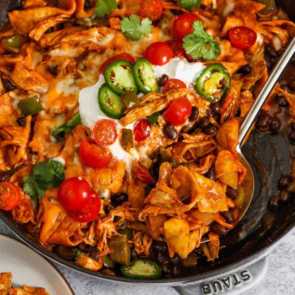 Enchilada Skillet in the pan with a spoon