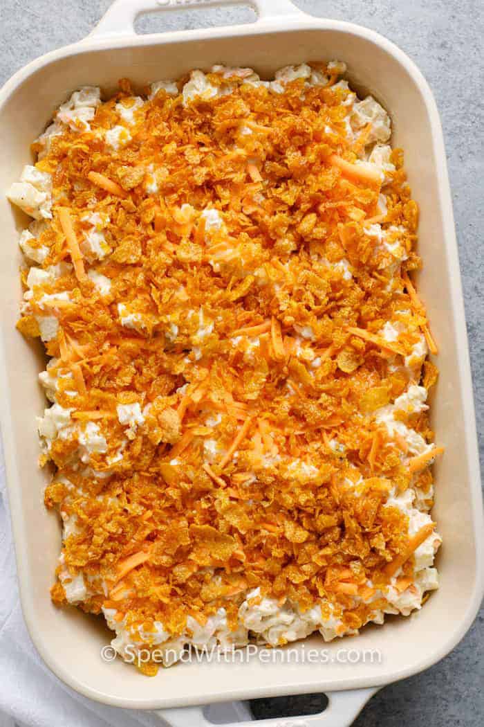 Funeral potatoes are the ultimate comfort food and a classic dish everyone loves. This easy recipe combines frozen hash browns with a creamy, cheesy sauce baked into a golden casserole. You can cook it in the oven or make it in a crock pot for a convenient make-and-take food contribution. The crispy topping adds the perfect crunch, and it’s simple to double for a crowd. These cheesy funeral potatoes are always a hit at gatherings. #spendwithpennies Funeral Potatoes in a dish before cooking