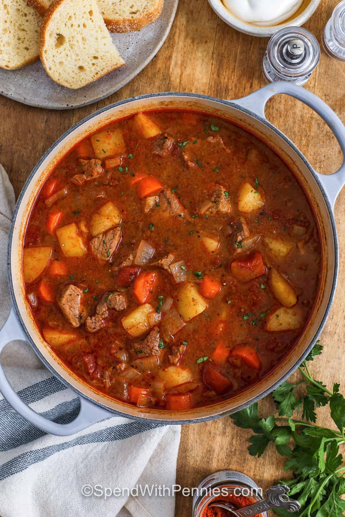 Hungarian goulash is a rich, hearty recipe filled with tender beef simmered in a flavorful tomato broth seasoned with sweet paprika. This comforting meal is cozy and delicious, especially when served with sour cream or a slice of crusty bread. Add carrots or potatoes for extra heartiness and flavor. Try making it in a Dutch oven or slow cooker for an easy family dinner everyone will love. #spendwithpennies Hungarian Goulash in a pot