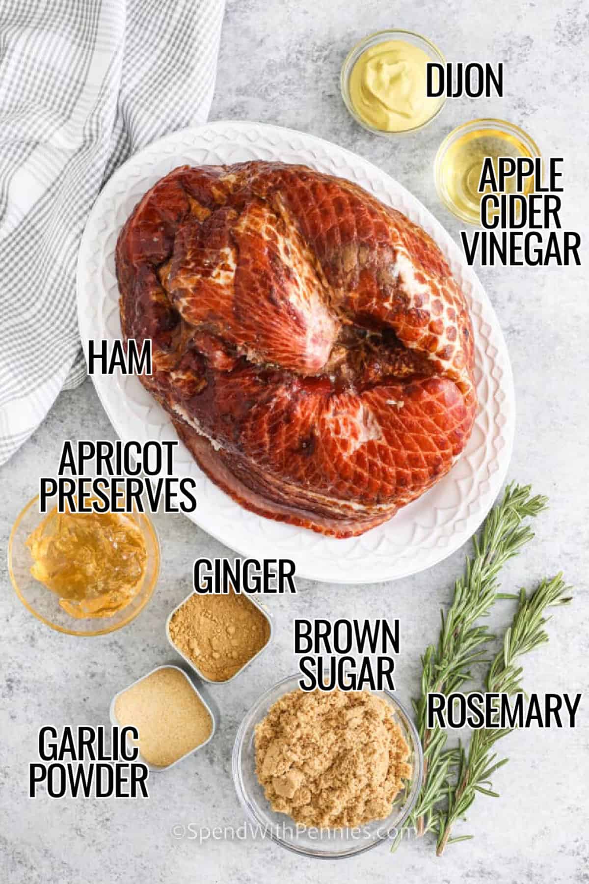 Crockpot ham is an effortless way to create a holiday-worthy centerpiece. This spiral ham recipe features a brown sugar and apple preserve glaze enhanced with Dijon mustard and garlic. Slow cooking ensures the meat stays tender and flavorful, while rosemary gives it a subtle aroma. Serve with mashed potatoes and make leftovers into a tasty ham and bean soup. Leftover slices are perfect for sandwiches or breakfast recipes that are just as delicious the next day. #spendwithpennies ingredients with labels to make crockpot ham