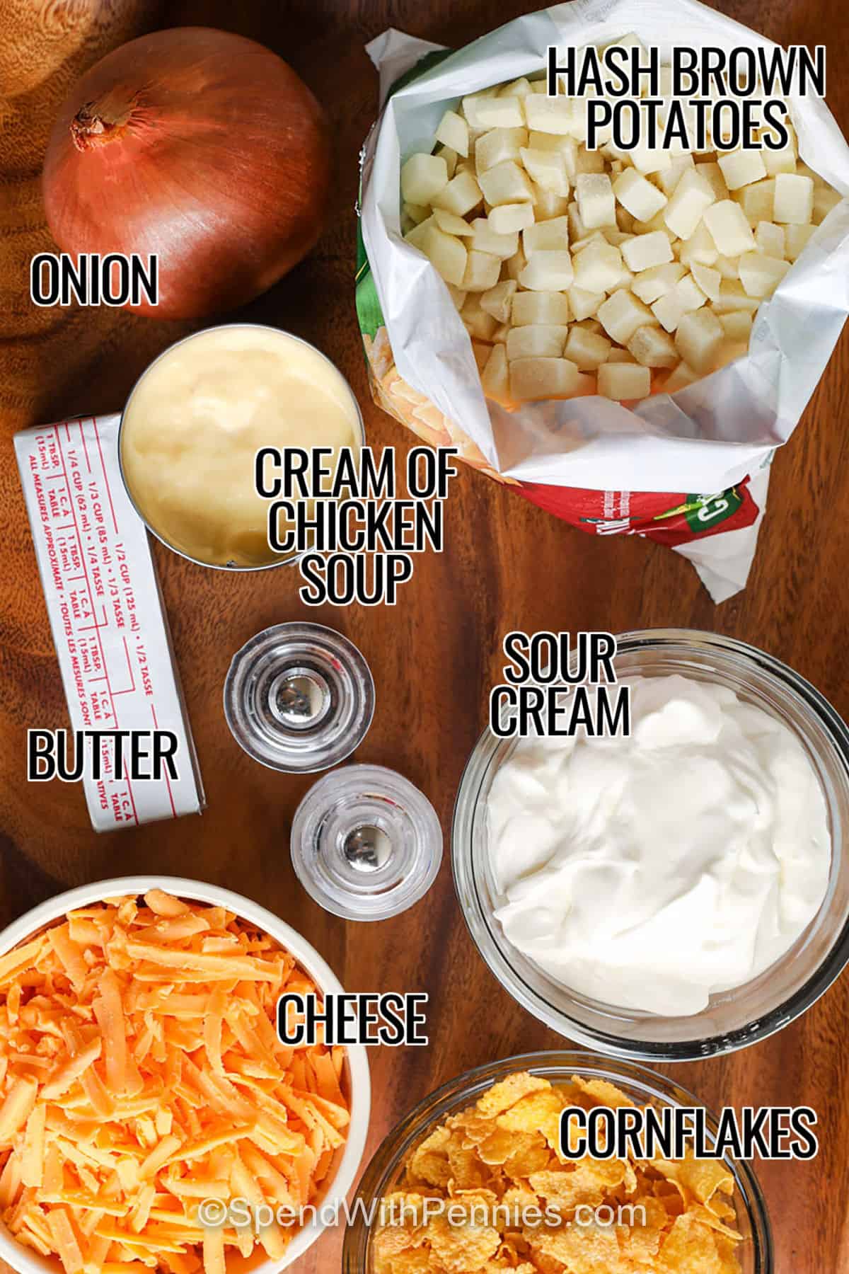 Cheesy funeral potatoes make the best comfort dish for contributing to a post-funeral buffet or any event. Frozen hash brown potatoes are cooked in a casserole with a creamy and cheesy sauce, under a crunchy cornflake topping. This dish is easy to make and serve from a crock pot. Swap diced potatoes for the hash browns if you prefer. Add this funeral potatoes recipe to your list of dependable, and always appreciated comfort dishes. #spendwithpennies onion , hash brown potatoes , cream of chicken soup , butter , sout cream , cheese , cornflakes with labels to make Funeral Potatoes