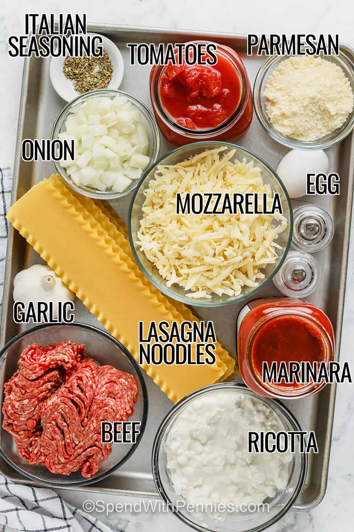This crockpot lasagna recipe is the perfect balance of convenience and flavor. Layers of noodles, seasoned beef, creamy ricotta, and mozzarella melt together in a rich sauce as it cooks. The slow cooker makes it so easy, and the result is cheesy, hearty, and full of comfort. Add a side of spinach or a veggie salad for the perfect meal. #spendwithpennies italian seasoning , tomatoes , parmesan , onion , mozzarella, garlic , lasagna noodles, marinara , ricotta , beef with labels to make Crockpot Lasagna
