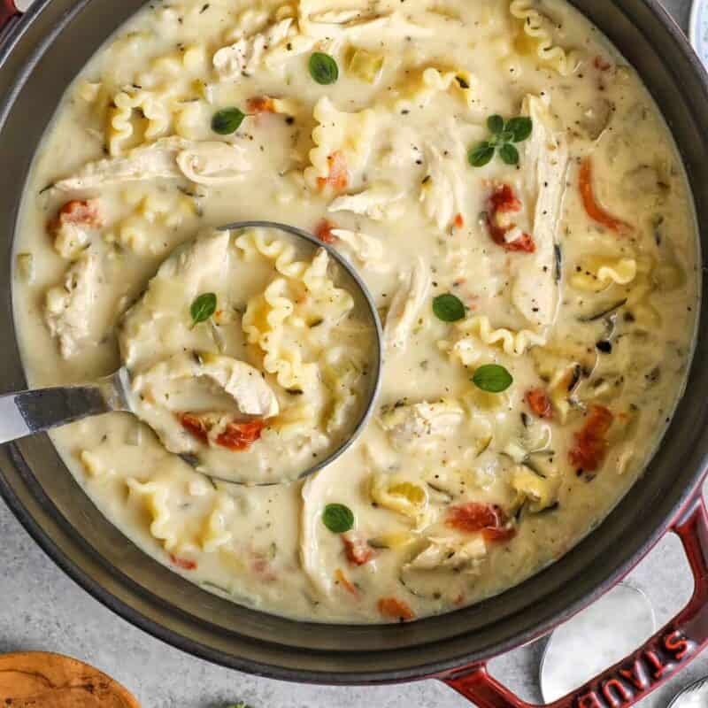 Dutch oven full of white lasagna soup with a ladle