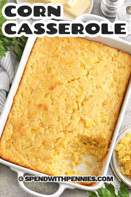 baked corn casserole with a piece taken out, with writing