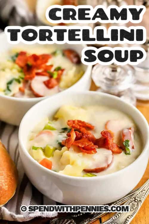Creamy tortellini soup is rich, hearty, and loaded with tender tortellini, smoky sausage, and fresh spinach in a velvety broth. This Italian-inspired recipe has layers of flavor from onion, garlic, and herbs, all simmered together in one pot. Parmesan cheese melts in at the end for the perfect finish. Serve it with crusty bread or a side salad for a cozy meal that feels like comfort in a bowl. #spendwithpennies plated Creamy Tortellini Soup with writing