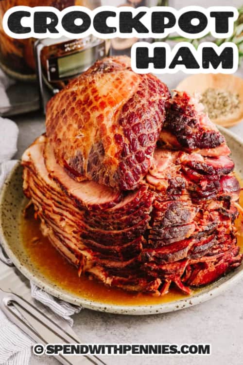 Crockpot ham is a show-stopping centerpiece for any meal. This recipe layers a sweet glaze over a spiral ham, letting brown sugar, apple preserves, and Dijon mustard create a flavorful crust. Cook it low and slow in your slow cooker, adding optional rosemary for an aromatic touch. Serve alongside roasted potatoes, a bean salad, or a warm soup for a comforting feast. Leftovers keep well and are perfect for sandwiches, breakfast hash, or a hearty dinner any day. #spendwithpennies sliced crockpot ham on a platter with writing