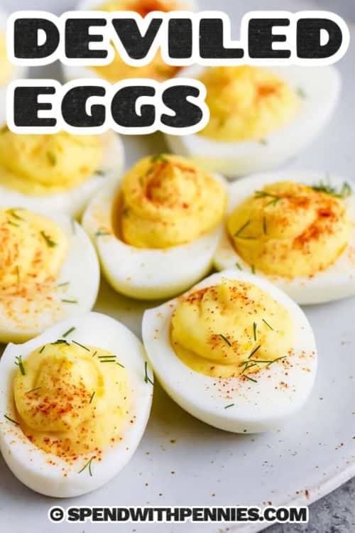 For an easy deviled eggs recipe that everyone will love, try this classic version. Boiled eggs are filled with a smooth mixture of mayonnaise, mustard, and vinegar, then garnished with paprika or bacon for a tasty finish. This dish is perfect for family gatherings, brunches, or festive occasions. You can also serve it with crackers or fresh bread for a complete snack. #spendwithpennies close up of creamy Deviled Eggs with a title
