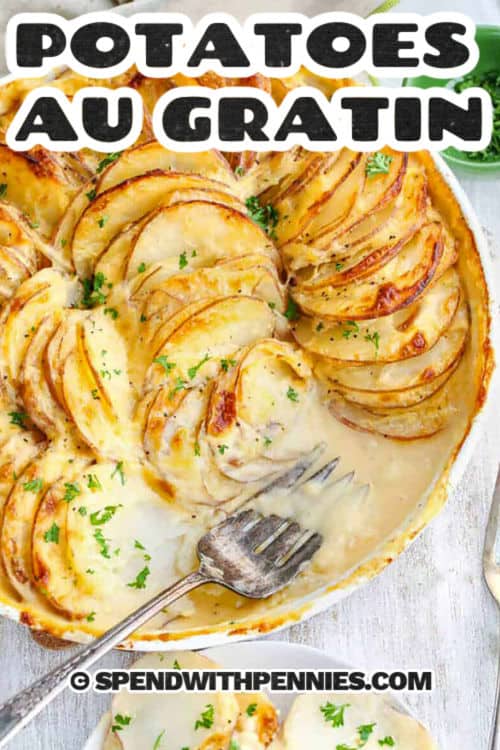 This recipe for potatoes au gratin makes the perfect comfort food with layers of tender potatoes and onions baked in a rich cheese sauce. Creamy cheddar and gruyere melt together for the best cozy flavor in every bite. This recipe is simple to make and goes great with ham, chicken, or any main dish. A golden top and soft center make it a family favorite that everyone loves to cook and share. #spendwithpennies Potatoes Au Gratin with a fork and a title