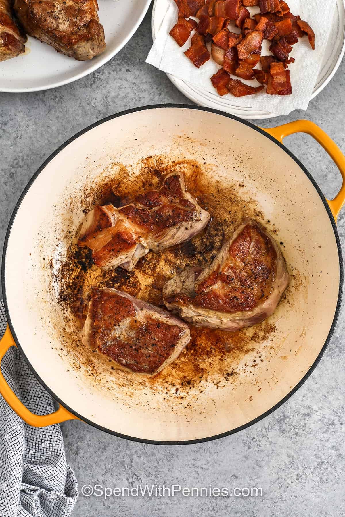 Pork and beans is a hearty and flavorful dish made with tender chunks of pork, baked beans, and a rich, sweet-tangy sauce that’s full of homemade goodness. A mix of smoky bacon, onion, garlic, and a slow-simmered broth with mustard and vinegar gives this dish its comforting depth. It’s a cozy, easy favorite that’s perfect for family dinners, weekend meals, or bringing along to potlucks. #spendwithpennies searing pork to make Pork and Beans