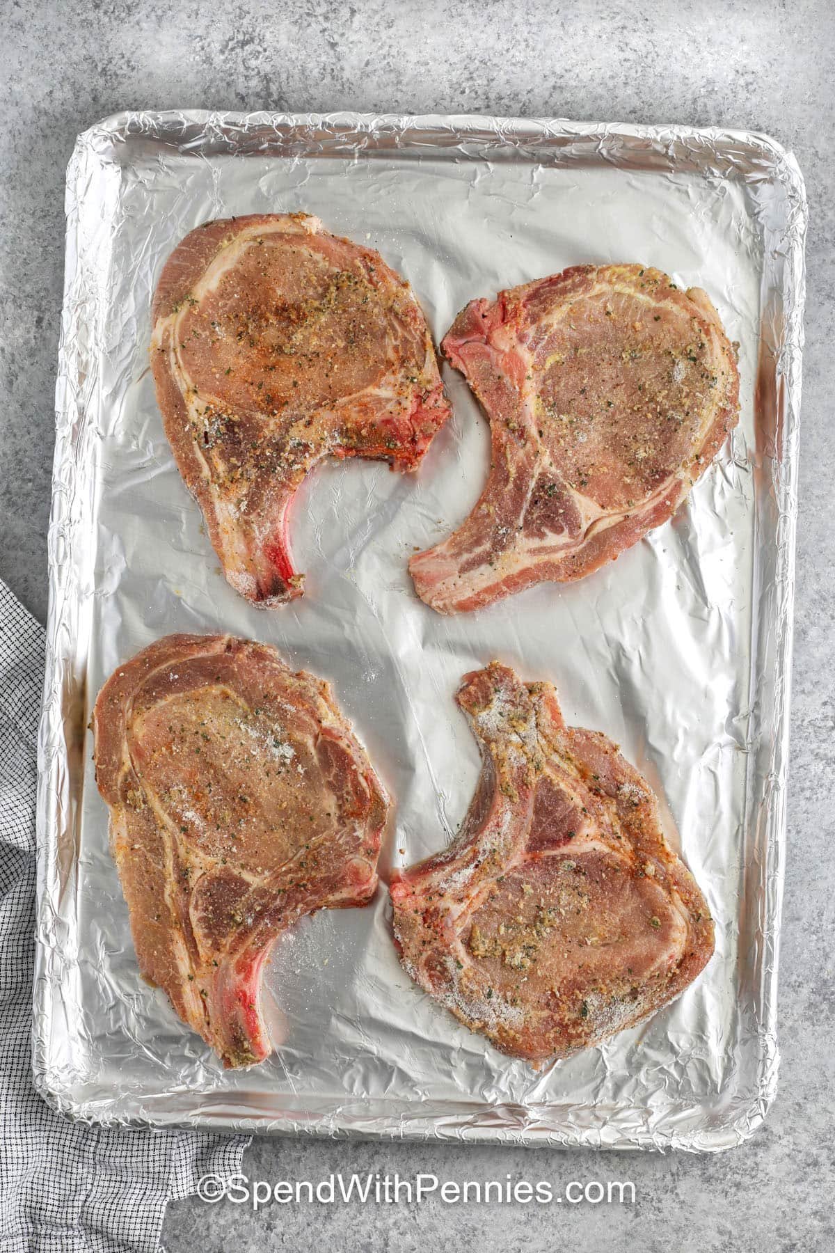 seasoned pork on a sheet pan to make Ranch Pork Chops
