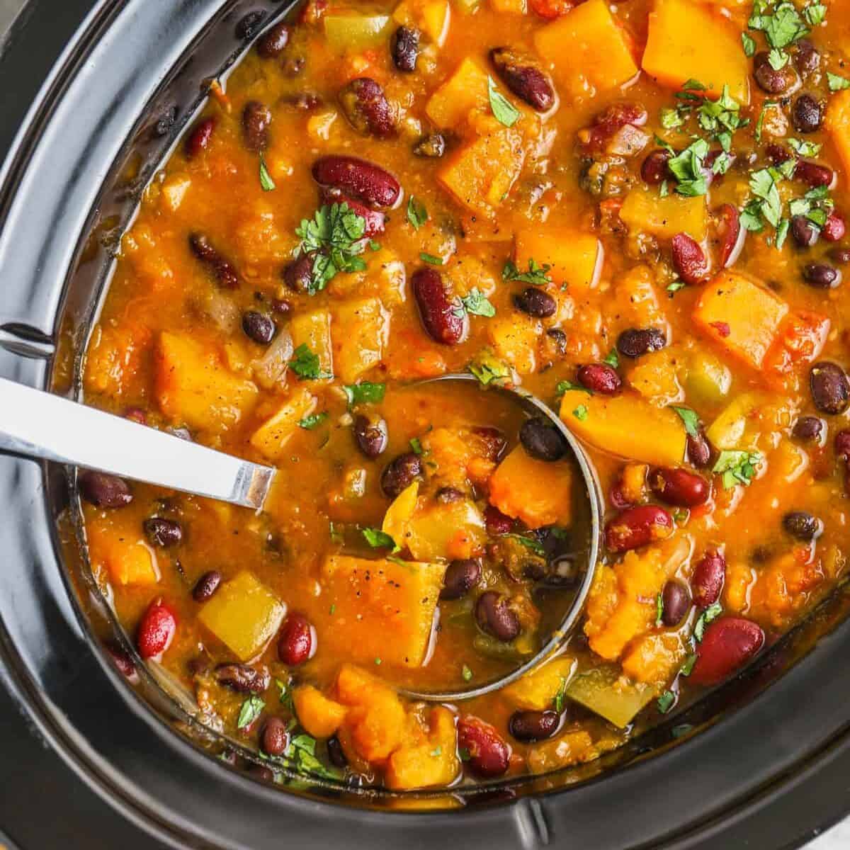 Slow Cooker Butternut Squash Chili in a slow cooker with a ladle