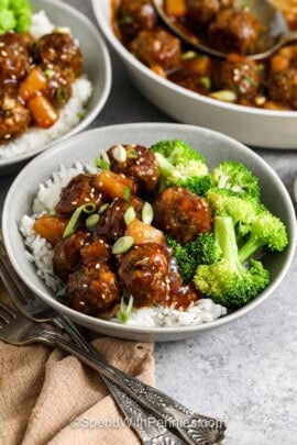closeup of teriyaki meatballs in a bowl with broccoli and rice