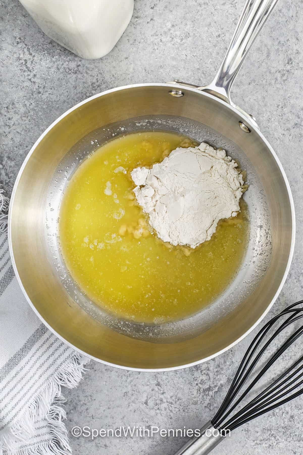 adding flour to melted butter to make Bechamel
