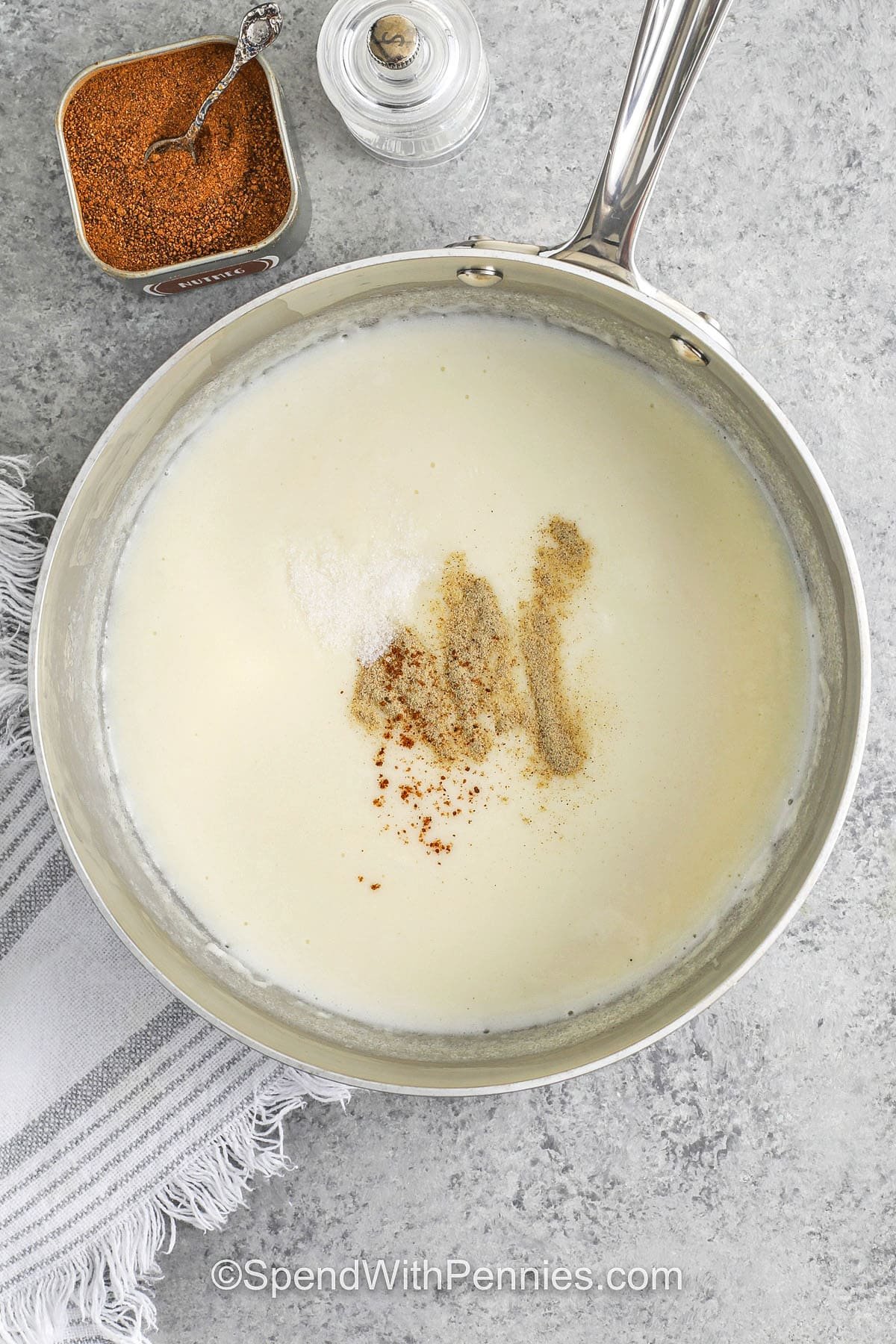 adding seasonings to Bechamel