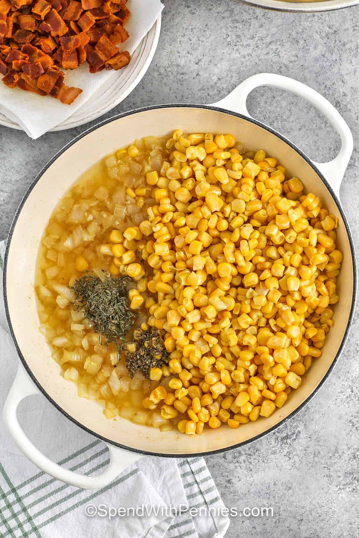 corn and herbs added to the pot of corn pasta