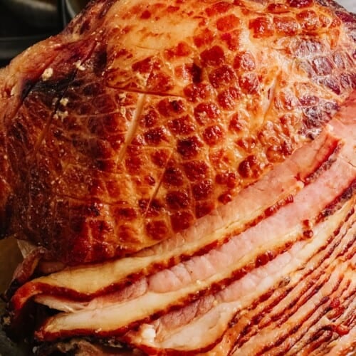 cooked crockpot ham on a plate with juices