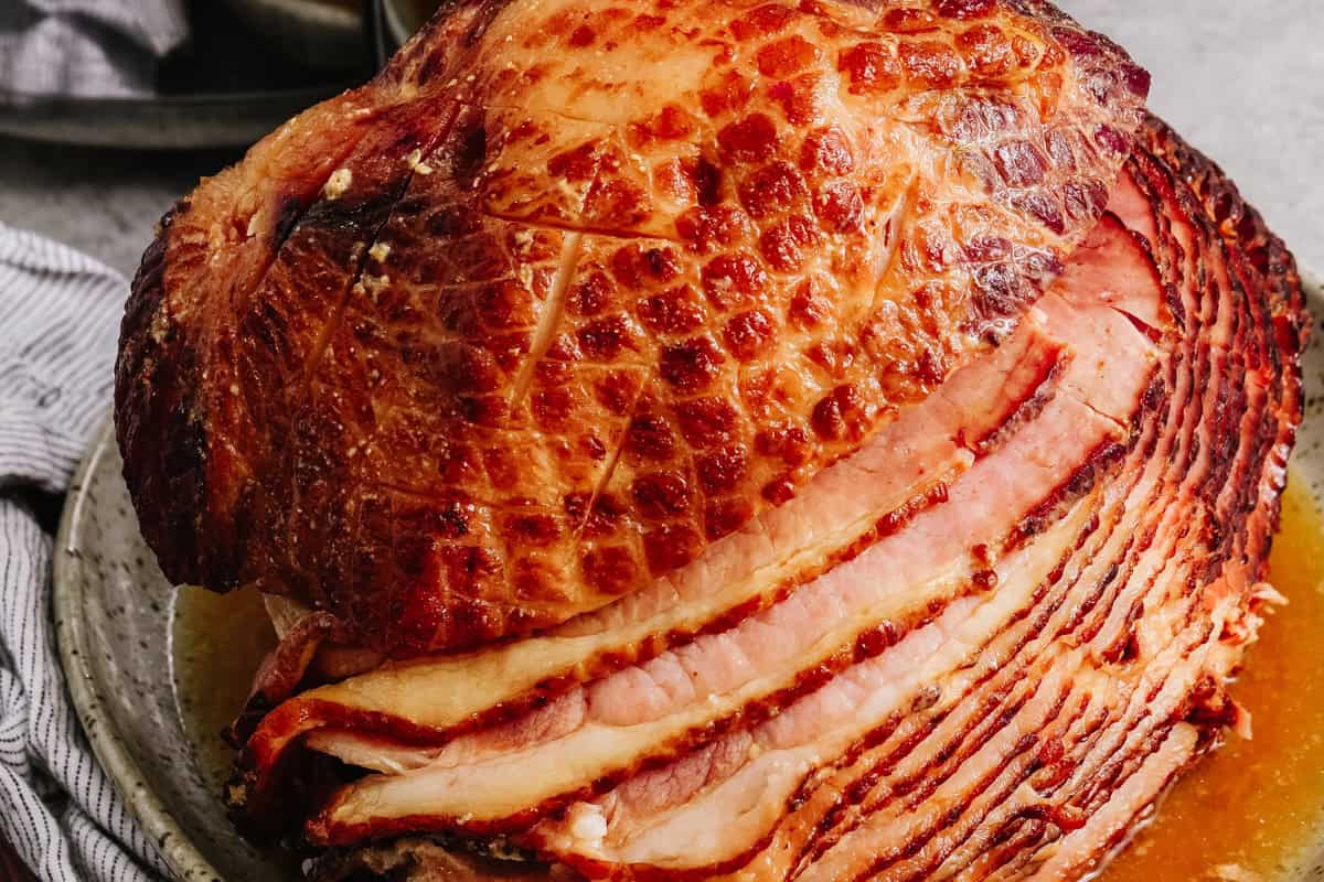 Crockpot ham with caramelized brown sugar glaze on a serving platter