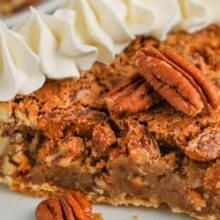 Easy pecan pie on a plate topped with pecans