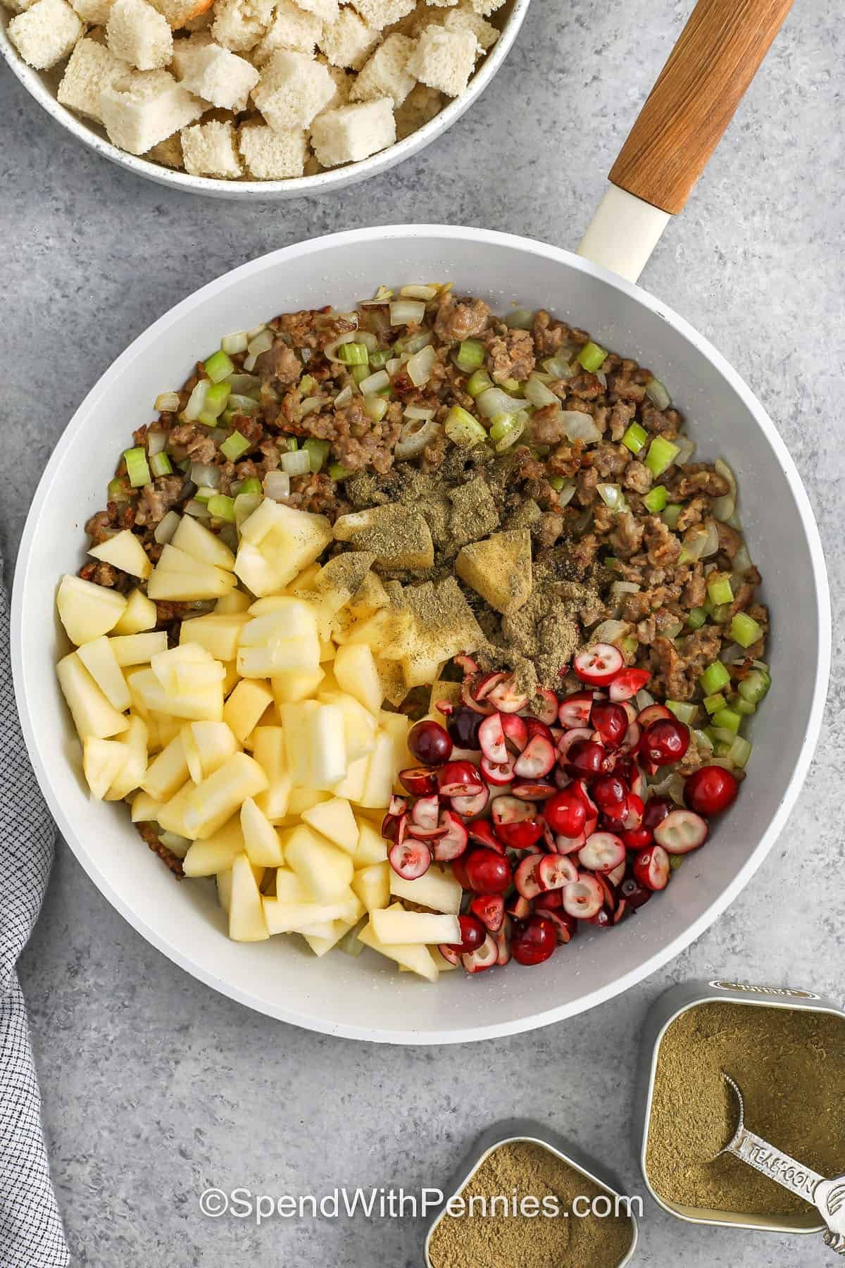 adding ingredients to pan for stuffing to make Pork Crown Roast