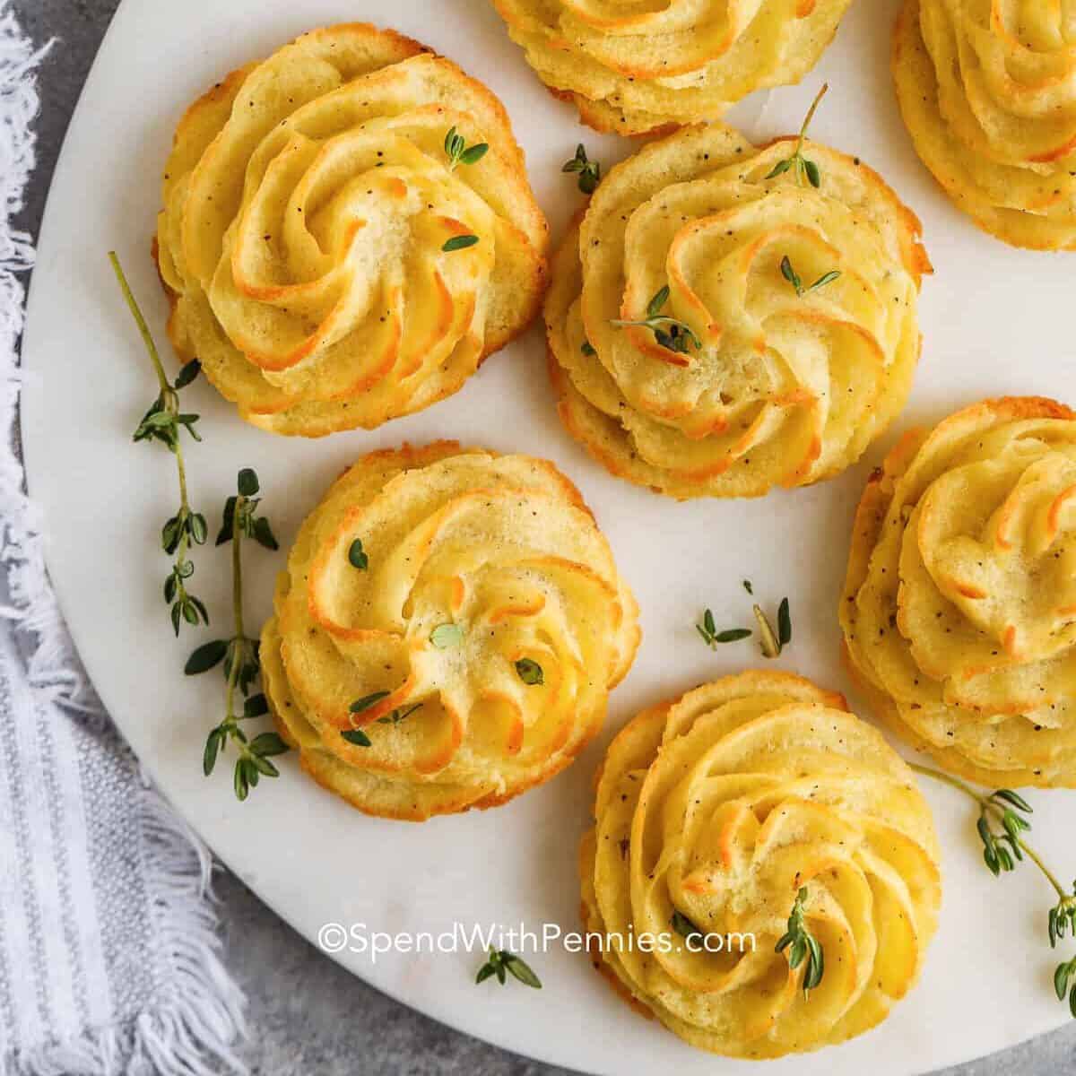 duchess potatoes with herbs on a marble board